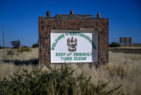 Sign with town coat of arms at the entrance to Keetmanshoop, Karas Region, Namibia