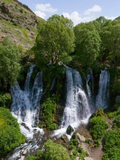 Large waterfall in mountainous surroundings with lush vegetation, aerial view, Shaki waterfall,