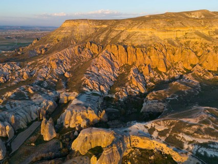 Breathtaking rock formations in the evening light in a vast landscape, aerial view, Göreme National