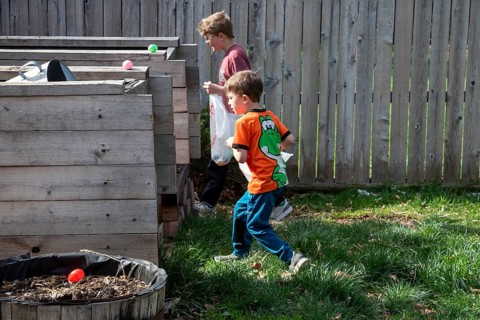 Wheat Ridge, Colorado - Brothers hunt for Easter eggson Easter Sunday in their family's back yard