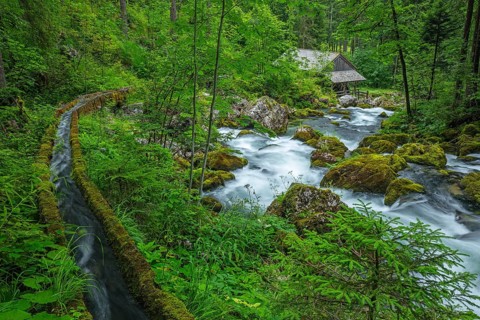 Golling watermill from above at the waterfall with the water pipe. Traditional mill in an alpine