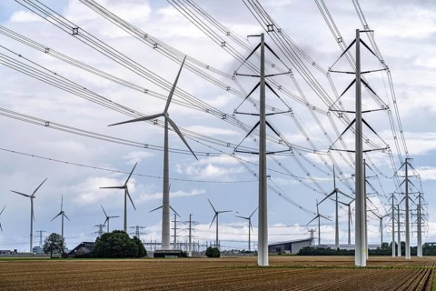 Wind turbines of a wind farm near Eemshaven, high-voltage power lines, Netherlands