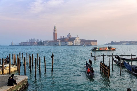 Boat dock at St Mark's Square, San Giorgio Maggiore church in the background, evening sky, Venice,