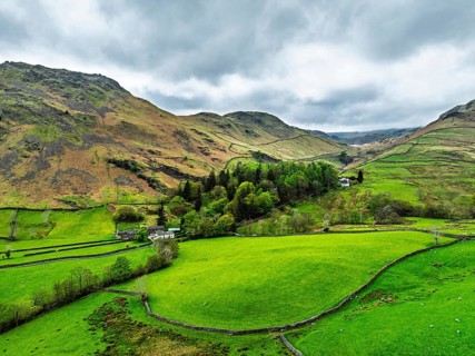 Farms and Mountains over road A591 from a drone, Grasmere Lake, Grasmere, Ambleside, Lake District,