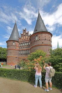 Historic Holsten Gate and tourists taking photos, Brick Gothic, Brick building, City gate,