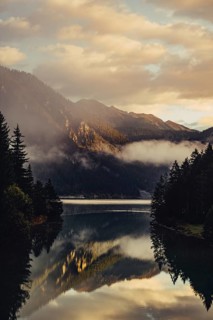 Sunrise with reflections and alpenglow in Lake Heiterwanger See in Tyrol in the Alps in Austria