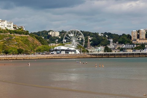 View to Princess Theatre and Ferris Wheel, Torre Abbey Sands sandy beach, Torquay, Devon, England,