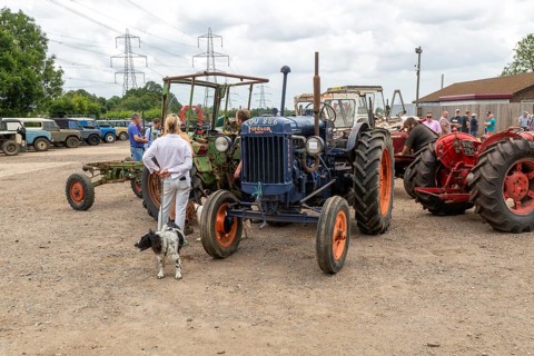 People viewing vintage Fordson tractor on display at auction, UK