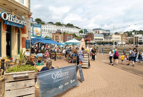 Offshore bar and restaurant, people walking on quayside, Vaughan Parade, Torquay, Devon, England,