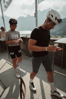Young man taking a coffee break while riding his racing bike on Lake Garda. Sunny weather and dolce