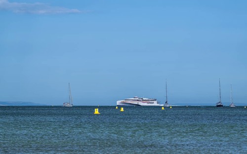 Boats on sea over Knoll Beach Studland, Poole, Dorset, England, United Kingdom