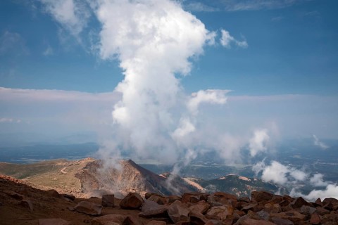 Colorado Springs, Colorado - Clourds rise near the summit of Pikes Peak, a 14, 115' mountain in