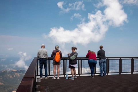 Colorado Springs, Colorado - Tourists line a viewint platform at the summit of Pikes Peak, a 14,