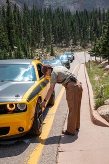 Colorado Springs, Colorado - A Pikes Peak ranger checks the temperature of brakes on a car