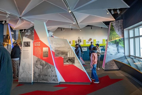 Colorado Springs, Colorado - Tourists view displays in the Summit Visitor Center at Pikes Peak, a