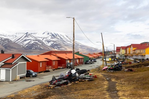 Colourful wooden houses, street, skidoos, Longyearbyen, Spitsbergen, Svalbard