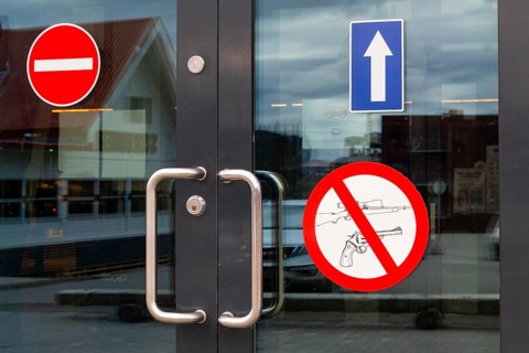 Firearms warning sign, entrance door, retail shop, Longyearbyen, Spitsbergen, Svalbard