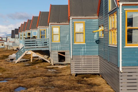Colourful houses with exposed supply lines, Longyearbyen, Spitsbergen, Svalbard