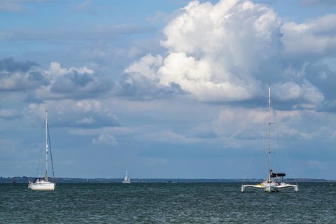 Boats on sea over Knoll Beach Studland, Poole, Dorset, England, United Kingdom