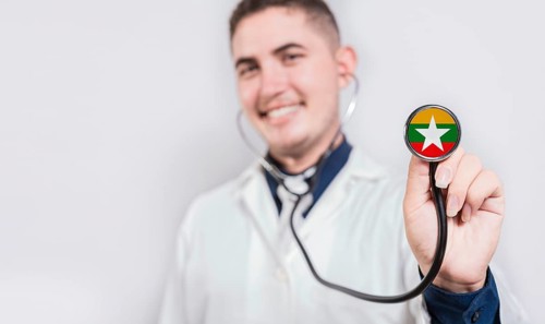 Doctor showing stethoscope with Myanmar flag. Myanmar national healthcare concept