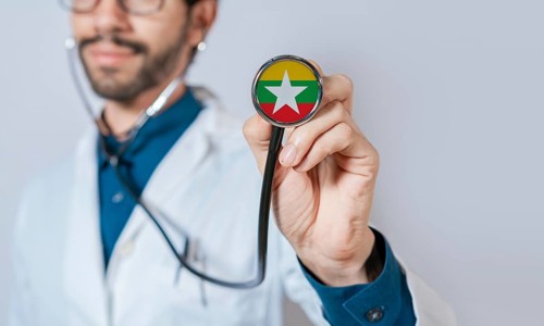Doctor holding stethoscope with Myanmar flag. Myanmar health and care concept, Myanmar flag on