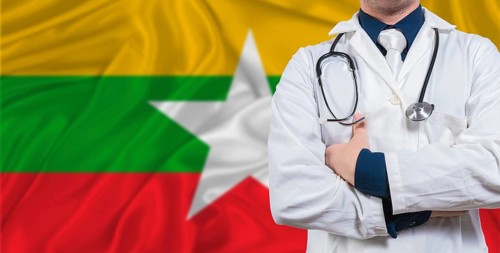 Male doctor with stethoscope on Myanmar flag. Doctor holding stethoscope on Myanmar flag