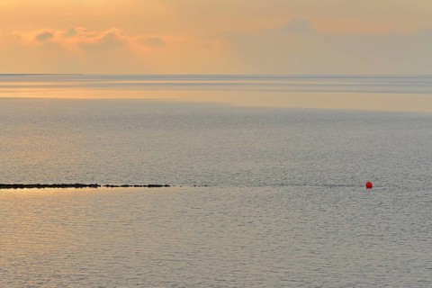 Evening mood at the Wadden Sea, stone groyne with red buoy, North Sea, Norddeich, Lower Saxony,