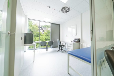 Modern office with large window and view of nature, Care Connect, vaccination kiosk for refugees,