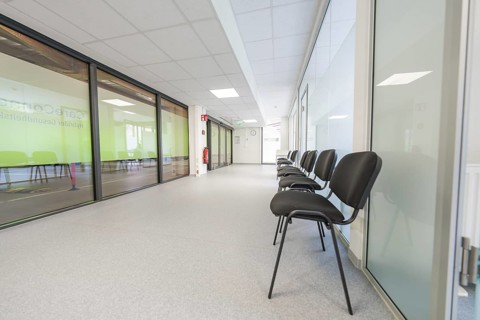 Modern, bright hallway with chairs and glass doors in the waiting area, Care Connect, vaccination