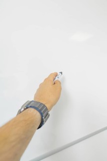 Close-up of a hand with a pen on a blackboard, Care Connect, vaccination kiosk for refugees, Calw,