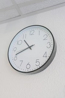 Round wall clock with white dial and black hands, Care Connect, vaccination kiosk for refugees,