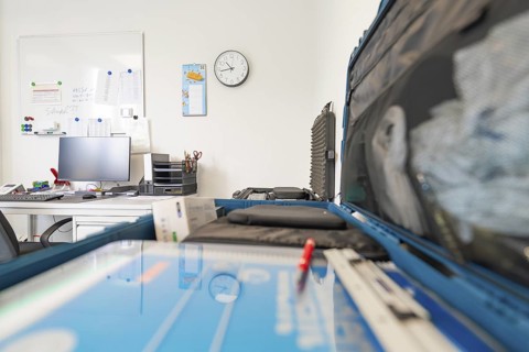 Modern office space with desk, monitor and wall clock, Care Connect, vaccination kiosk for
