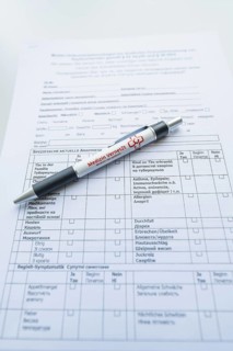 Biros on a completed form on a desk, Care Connect, vaccination kiosk for refugees, Calw, Germany