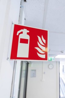 Fire extinguisher sign in an office corridor as a safety instruction, Care Connect, vaccination