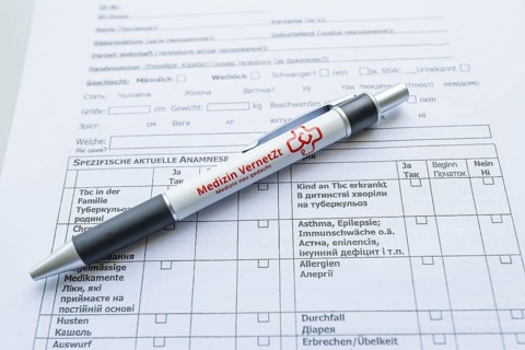 Biros lying on a medical form on a desk, Care Connect, vaccination kiosk for refugees, Calw,