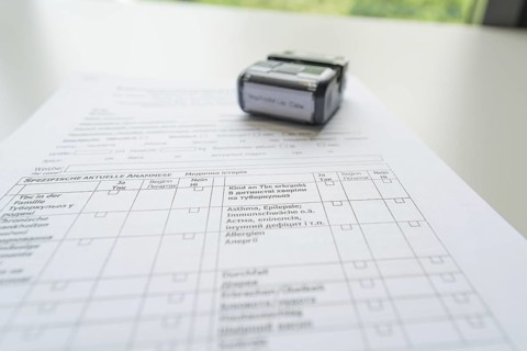 A completed form with a stamp on it, Care Connect, vaccination kiosk for refugees, Calw, Germany