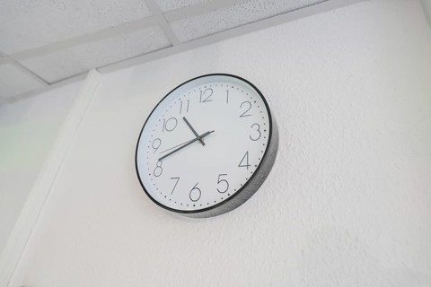 Plain white wall clock with black hands on the wall, Care Connect, vaccination kiosk for refugees,