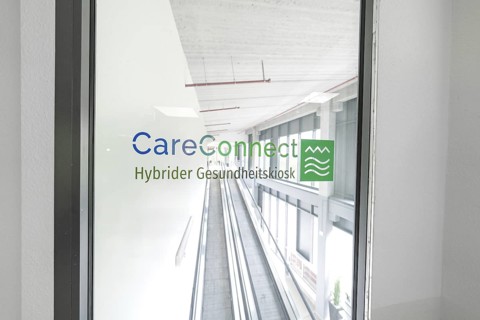 Bright escalator with CareConnect logo in a modern building, Care Connect, vaccination kiosk for