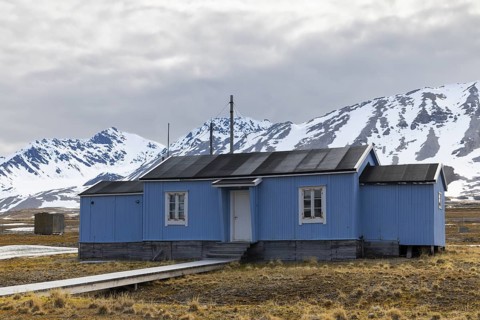 Wooden house in front of a mountain peak, Ny-Alesund, Spitsbergen, Svalbard