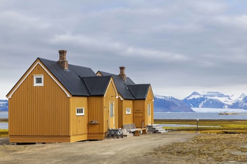 Wooden house against a mountain backdrop, Ny-Alesund, Spitsbergen, Svalbard