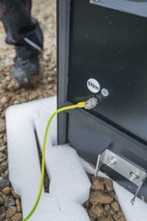 Underground cables are attached to a device and secured to the ground, installation of a charging