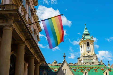 Rainbow flag on the Primatial Palace, in the background is the Old Town Hall of Bratislava,