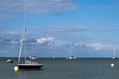 Boats on sea over Knoll Beach Studland, Poole, Dorset, England, United Kingdom