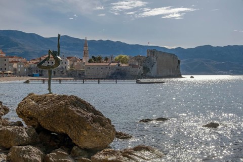 Statue of a ballerina against the background of the old town centre of Budva, Montenegro, Balkans
