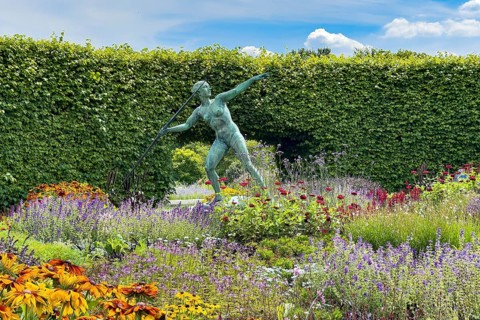 Sculpture Statue of bronze javelin thrower from 1937 by sculptor and artist Ernst Seger in flower