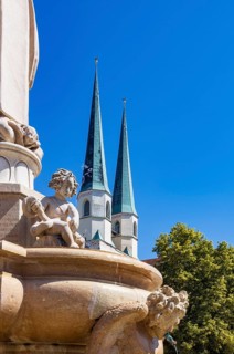 Marienbrunnen fountain on Kapellplatz with St.Philippus and Jakobus collegiate parish church, place