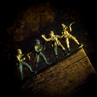 A group of toy soldiers are captured in motion as they navigate a steep incline, showcasing