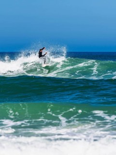 Surfer riding a wave on Contis beach, Saint Julien en Born, Saint-Julien-en-Born, Landes, France