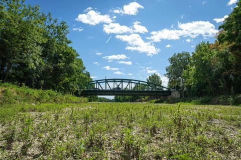 Bridge spans dry riverbed of the Schwarza, surrounded by trees, Neunkirchen, Lower Austria, Austria