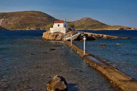 White chapel with red roof on rocky island, accessible via a long footbridge, chapel, church, Agios